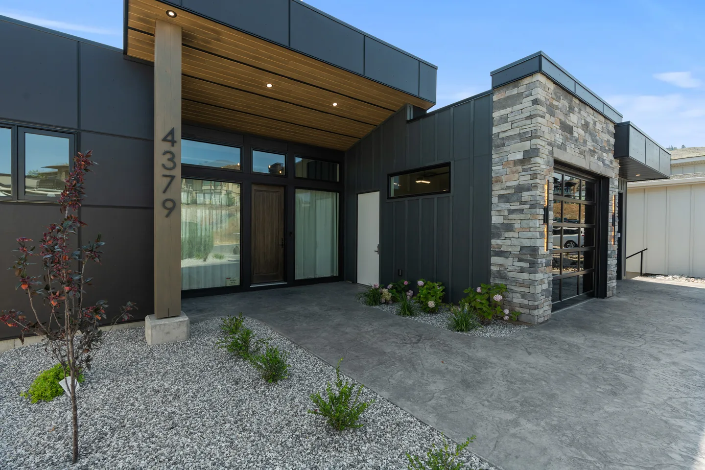 Covered front entry with stone and a wood soffit